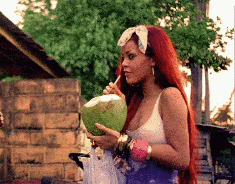 Rihanna peacefully sipping from a coconut