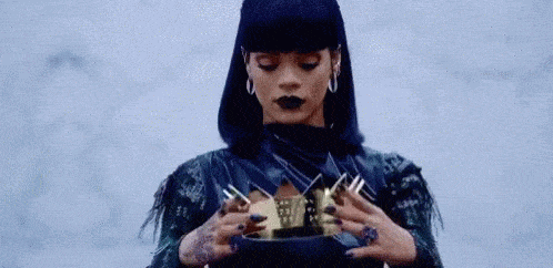 Rihanna putting a crown on her head!